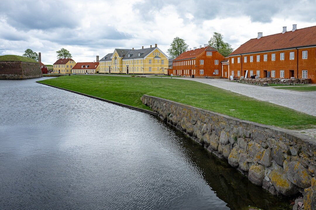 Photographer walking through a Danish village with a camera