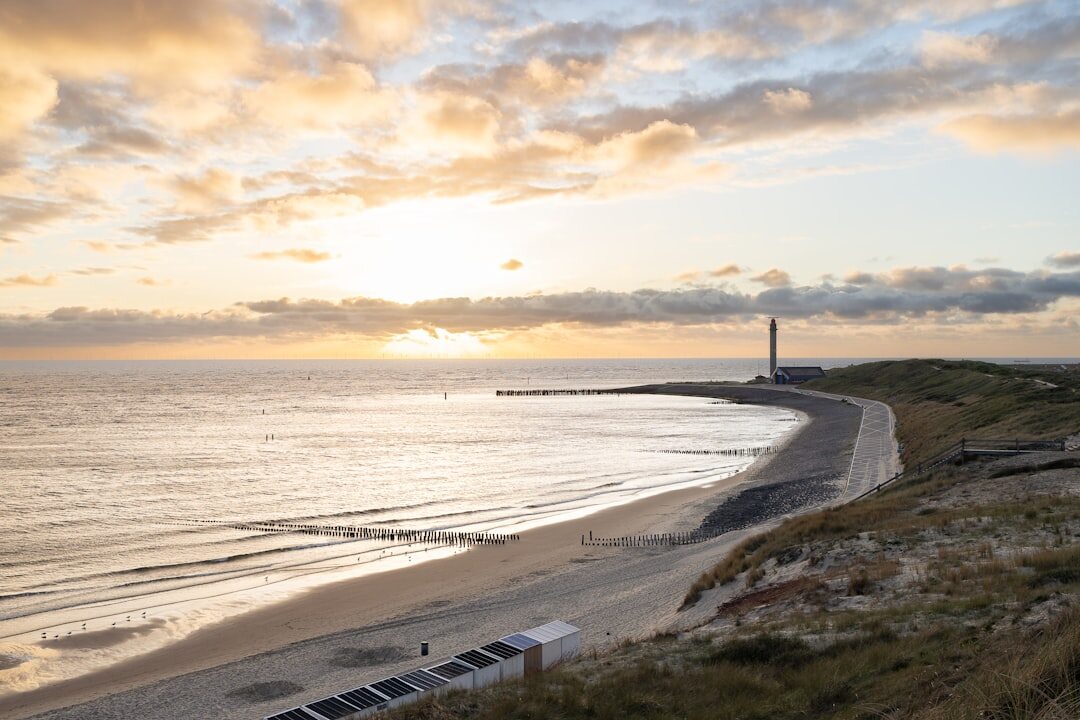Danish lighthouse on a windy coastline at sunset
